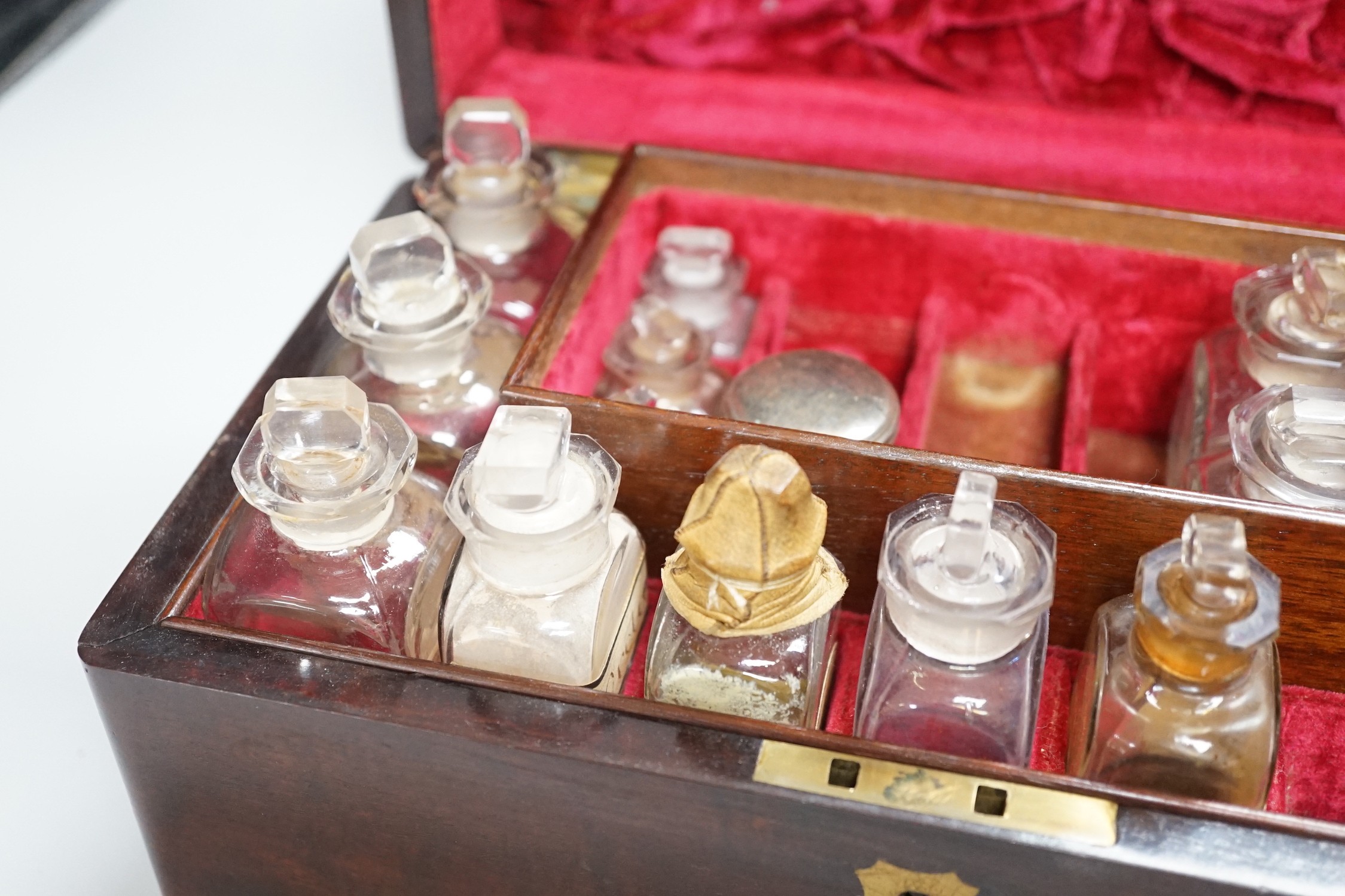 A 19th century mahogany cased travelling apothecary set with glass flasks, handle plate engraved ‘Dr.Tulk’, 26cm wide